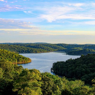 The evening sun shining over Norfork Lake and the surrounding mountains in Mountain Home, Arkansas