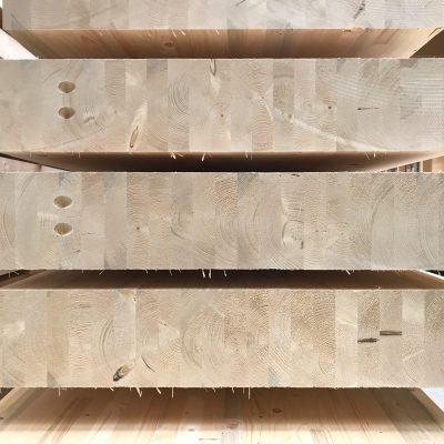 stack of Engineered wood timber beams. Mass Timber glulam construction material.